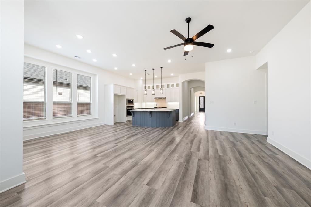 1606 Bulls Eye Road Mansfield, TX 76063 - Photo 3 of 27 a view of a kitchen with wooden floor and a ceiling fan