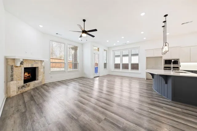 a view of a kitchen with a stove wooden floor and a fireplace