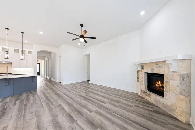 a view of a kitchen with a sink and a fireplace