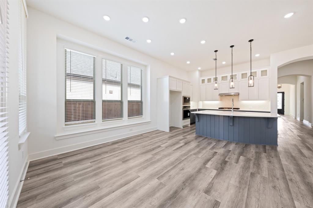 1606 Bulls Eye Road Mansfield, TX 76063 - Photo 8 of 27 a large kitchen with kitchen island a large counter top and stainless steel appliances