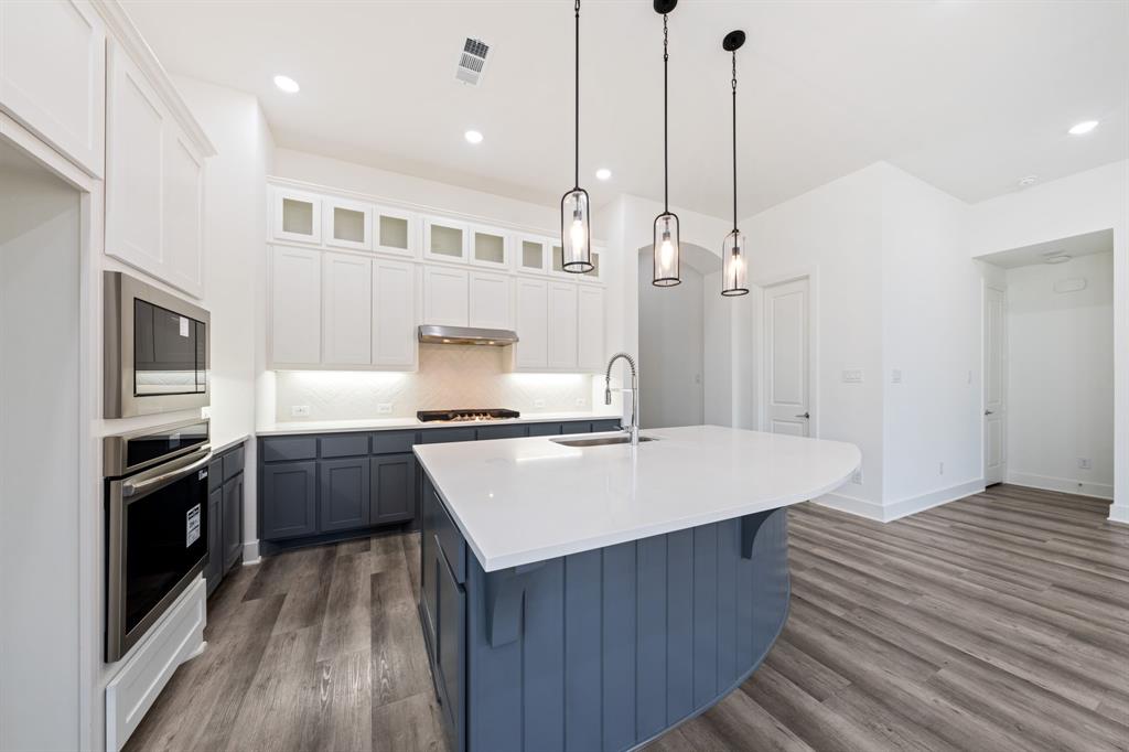1606 Bulls Eye Road Mansfield, TX 76063 - Photo 9 of 27 a kitchen with kitchen island a sink stove and refrigerator