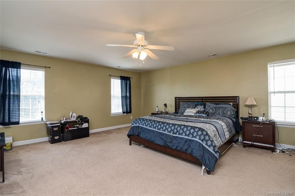 982 Ramsgate Drive Southwest Concord, NC 28025 - Photo 13 of 22 a spacious bedroom with a bed and a couch