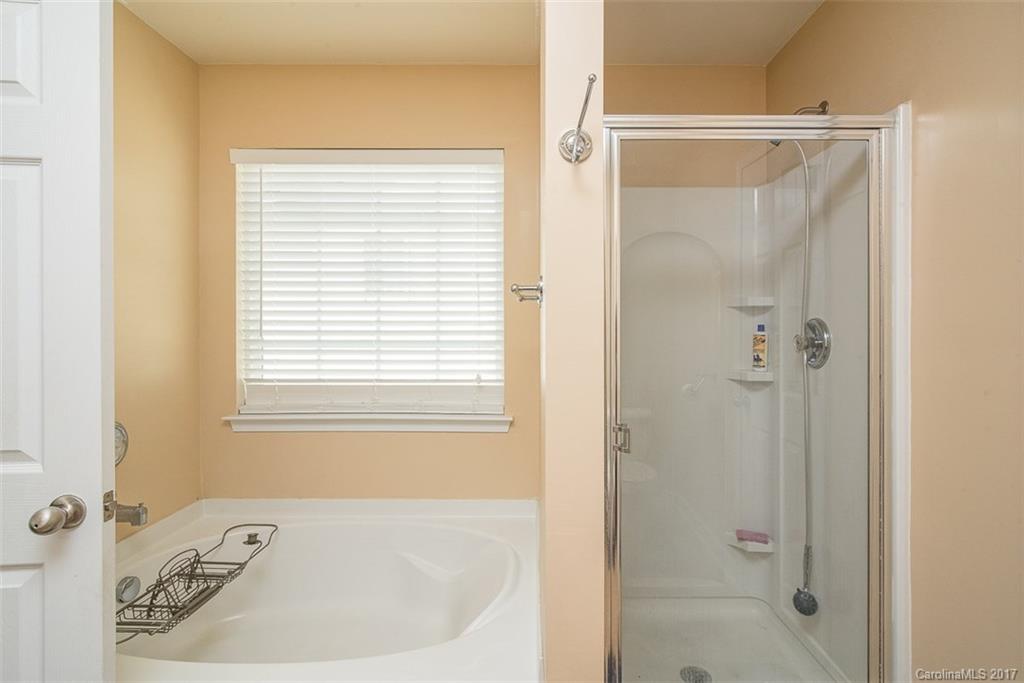 982 Ramsgate Drive Southwest Concord, NC 28025 - Photo 14 of 22 a white bath tub sitting next to a shower