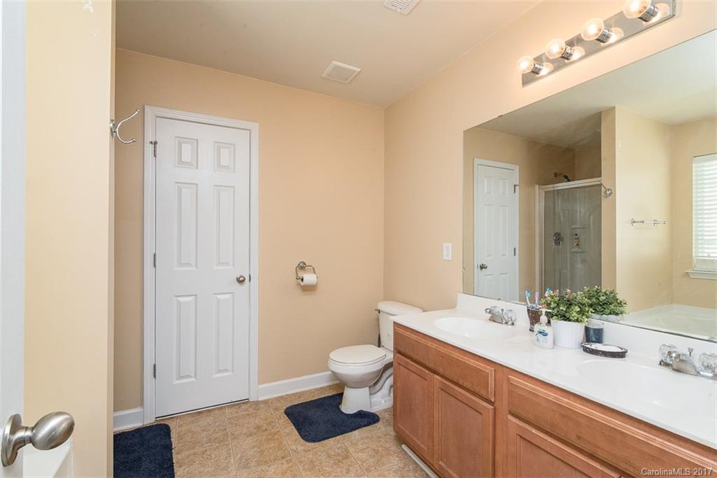 982 Ramsgate Drive Southwest Concord, NC 28025 - Photo 15 of 22 a bathroom with a sink a toilet and shower