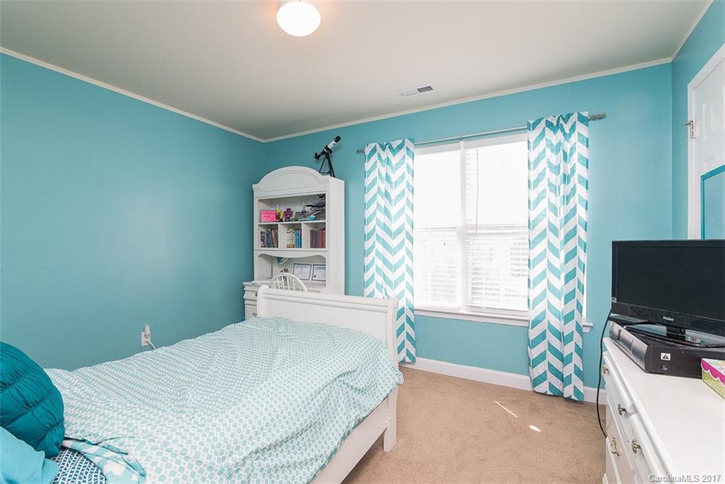 982 Ramsgate Drive Southwest Concord, NC 28025 - Photo 16 of 22 a bedroom with a bed and a flat screen tv