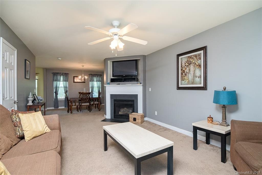 982 Ramsgate Drive Southwest Concord, NC 28025 - Photo 3 of 22 a living room with furniture a fireplace and a flat screen tv