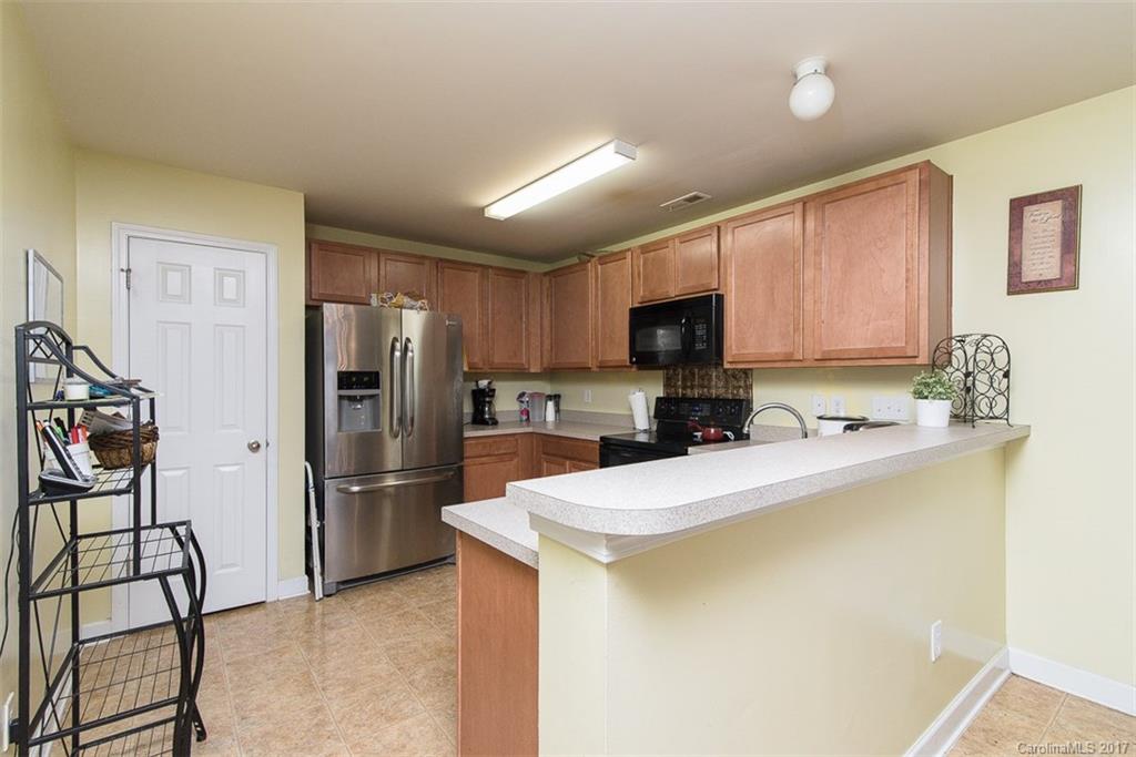 982 Ramsgate Drive Southwest Concord, NC 28025 - Photo 8 of 22 a kitchen with stainless steel appliances a refrigerator sink and cabinets