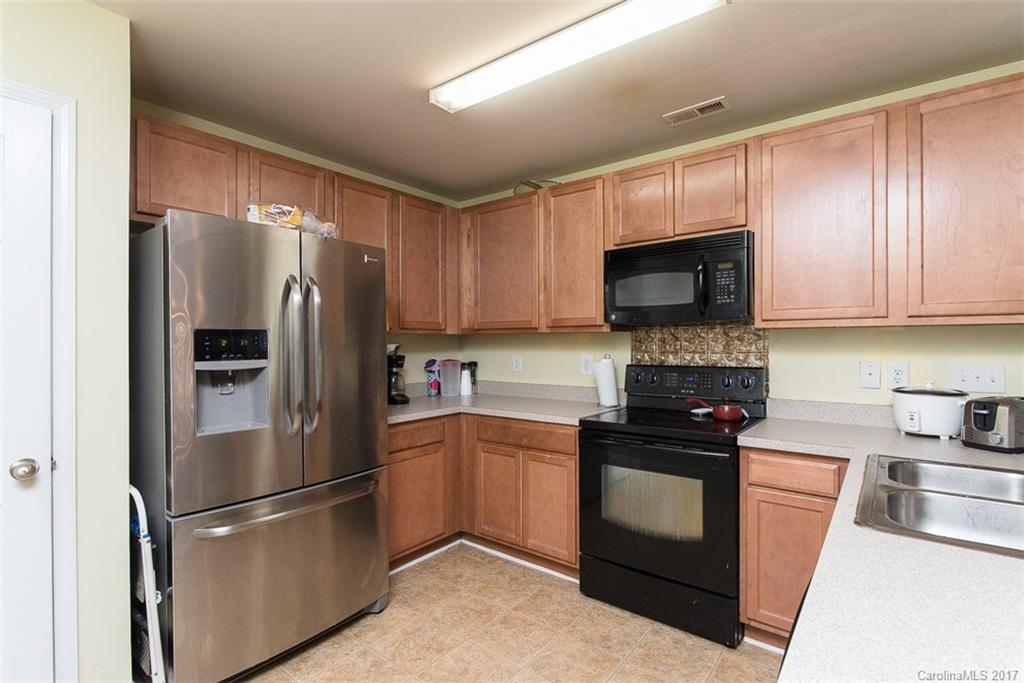 982 Ramsgate Drive Southwest Concord, NC 28025 - Photo 9 of 22 a kitchen with stainless steel appliances granite countertop a refrigerator stove a sink and a microwave