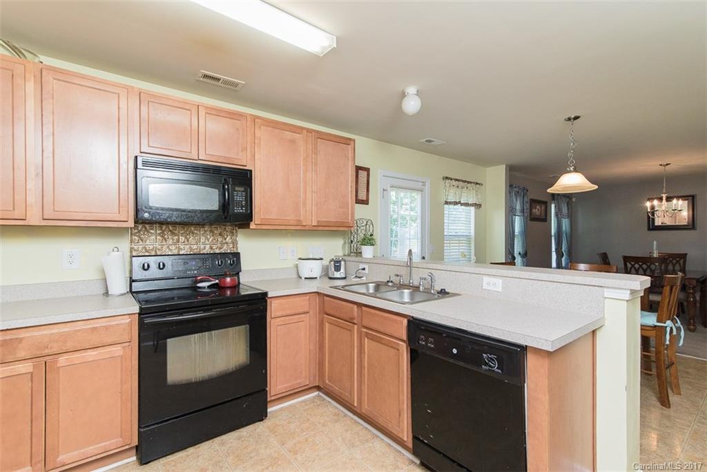 982 Ramsgate Drive Southwest Concord, NC 28025 - Photo 10 of 22 a kitchen with a sink stove and microwave