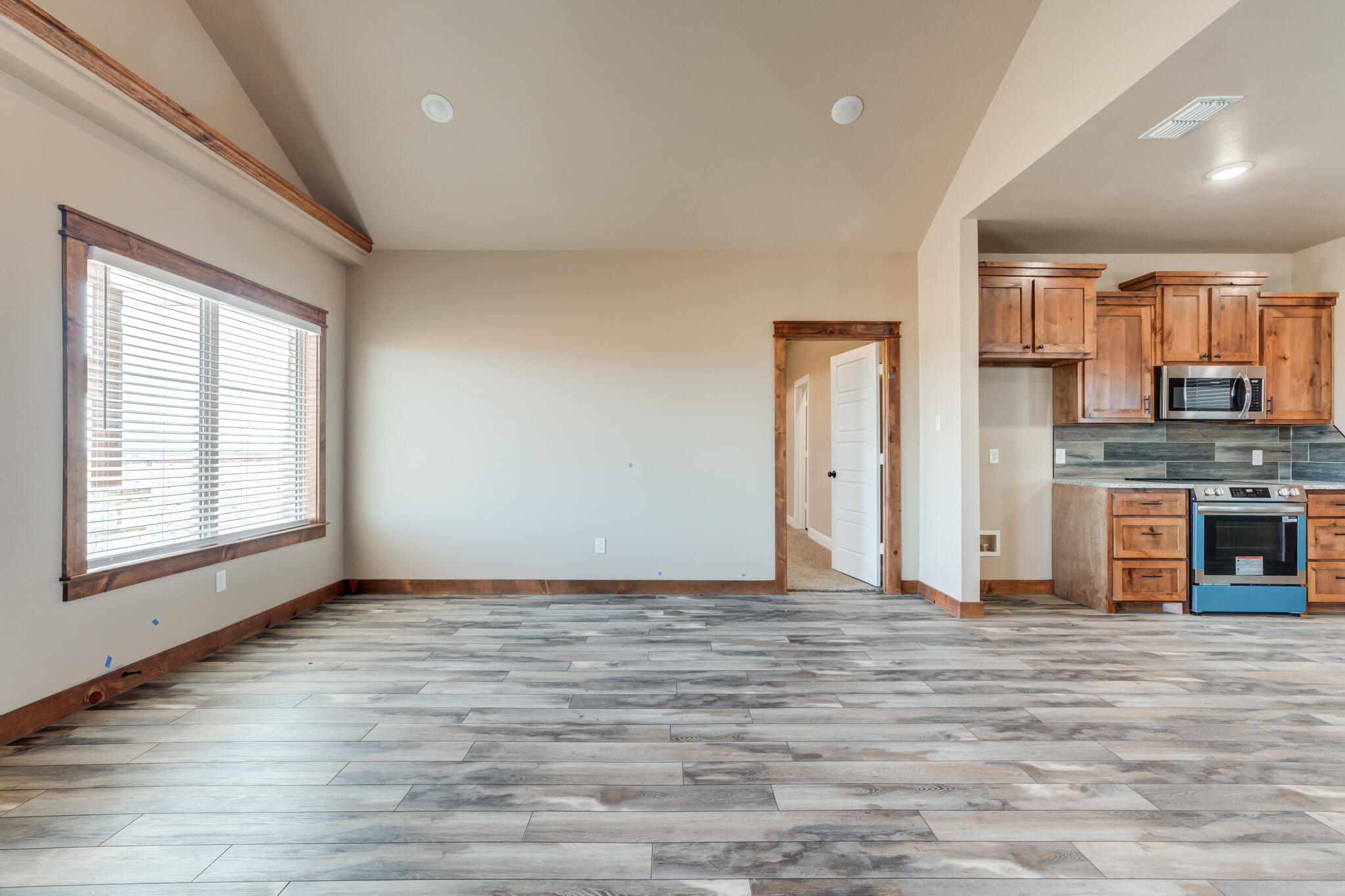 12401 North C R 2900 Lubbock, TX 79403 - Photo 11 of 40 a view of an empty room with window and wooden floor