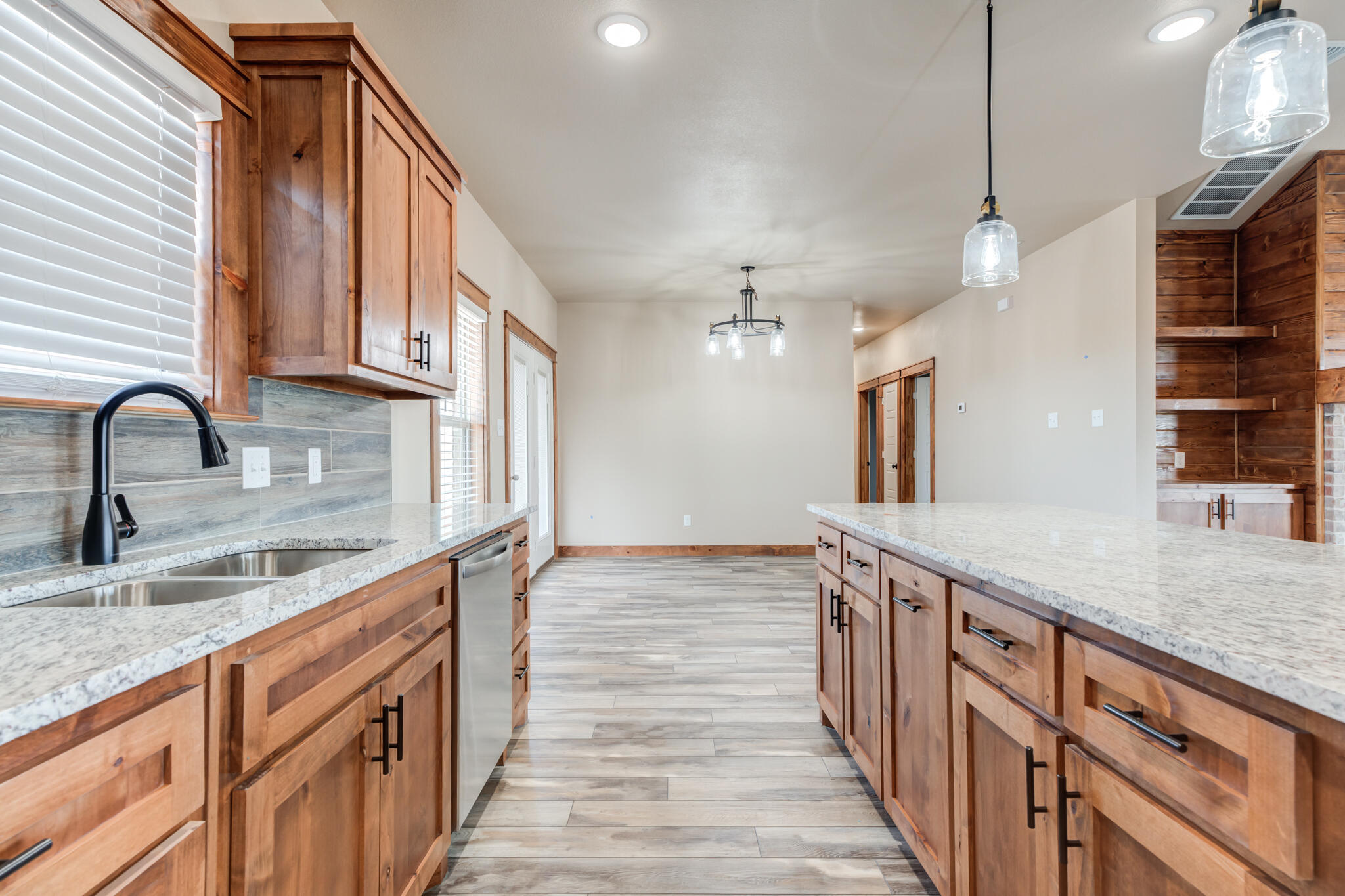 12401 North C R 2900 Lubbock, TX 79403 - Photo 18 of 40 a kitchen with stainless steel appliances granite countertop a sink and a stove