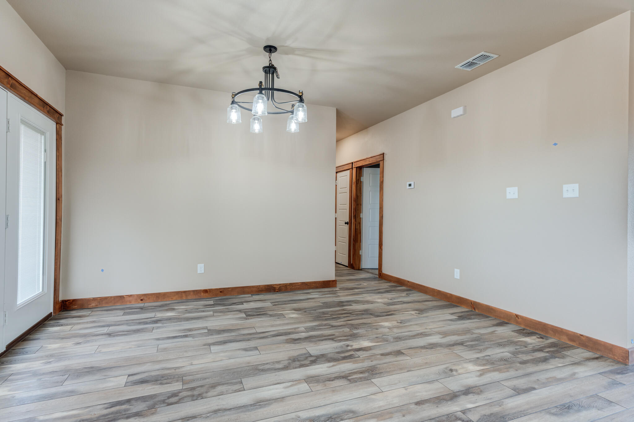 12401 North C R 2900 Lubbock, TX 79403 - Photo 20 of 40 a view of an empty room with wooden floor