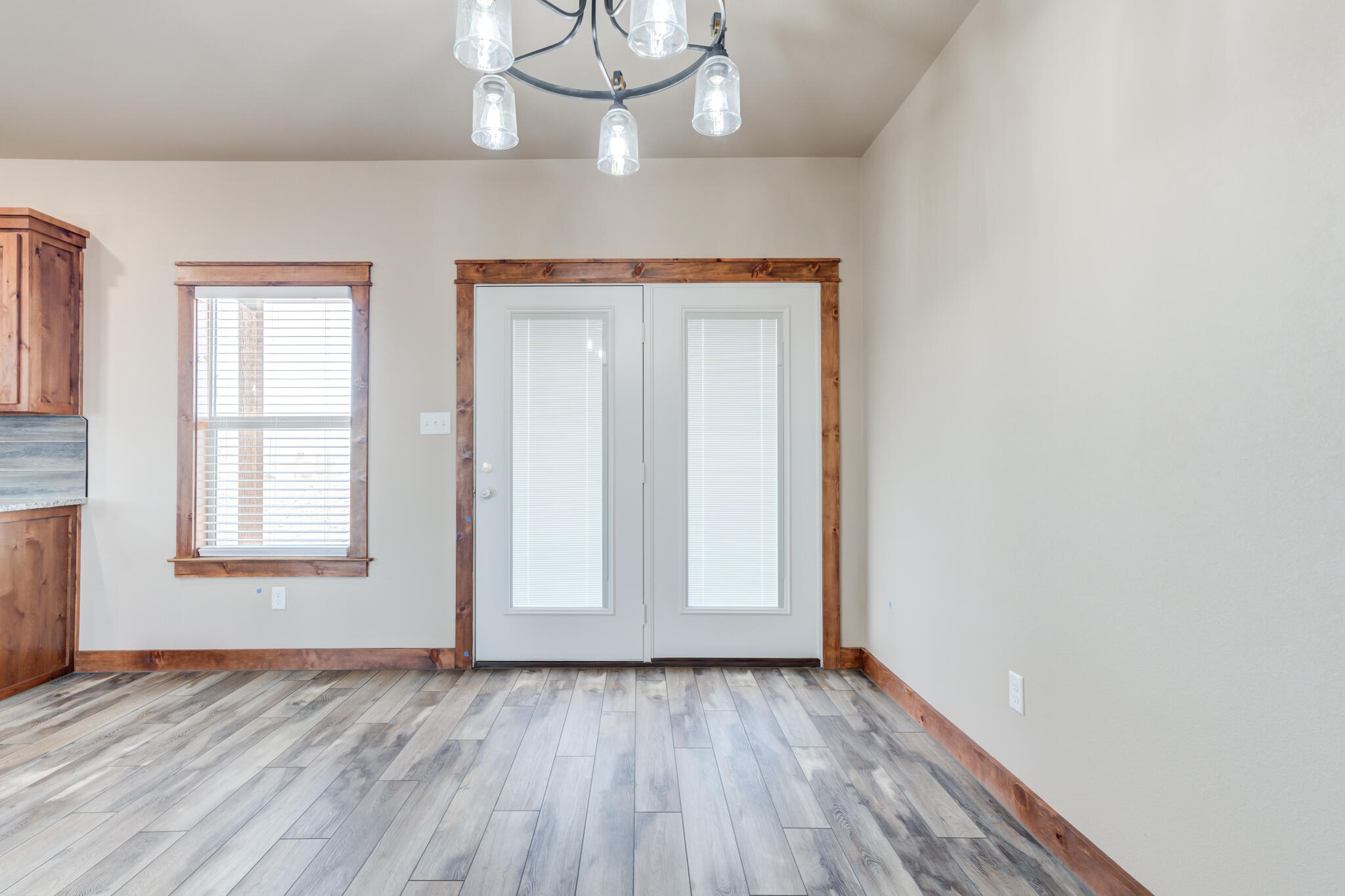 12401 North C R 2900 Lubbock, TX 79403 - Photo 22 of 40 an empty room with wooden floor cabinet and windows