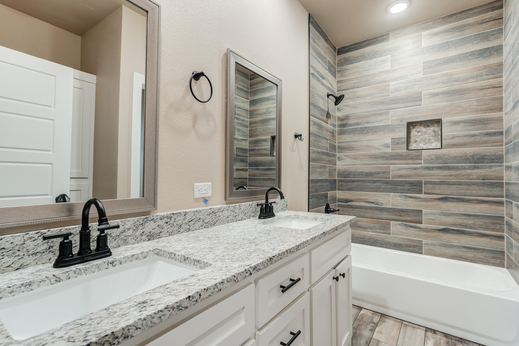 12401 North C R 2900 Lubbock, TX 79403 - Photo 24 of 40 a bathroom with a granite countertop sink and a bathtub