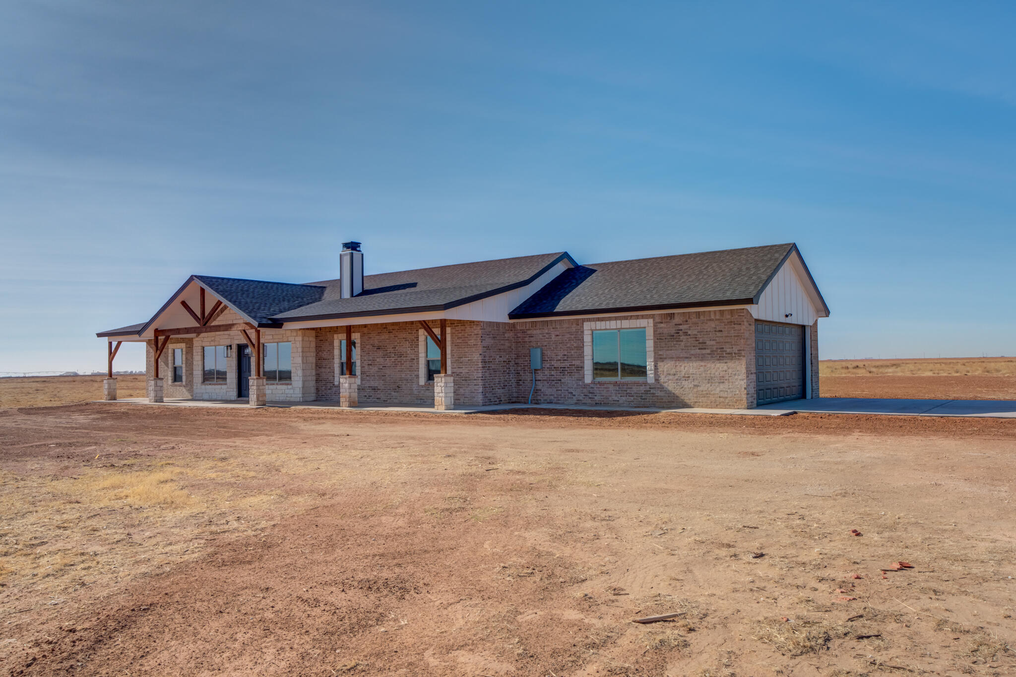12401 North C R 2900 Lubbock, TX 79403 - Photo 4 of 40 a front view of a house with a yard