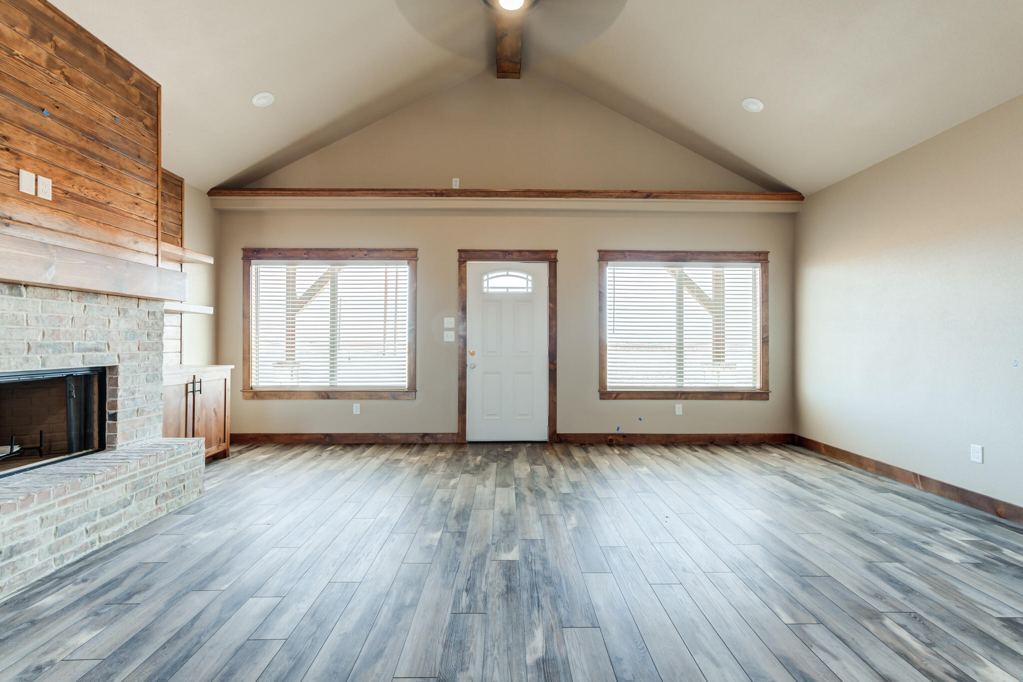 12401 North C R 2900 Lubbock, TX 79403 - Photo 5 of 40 an empty room with wooden floor fireplace and windows