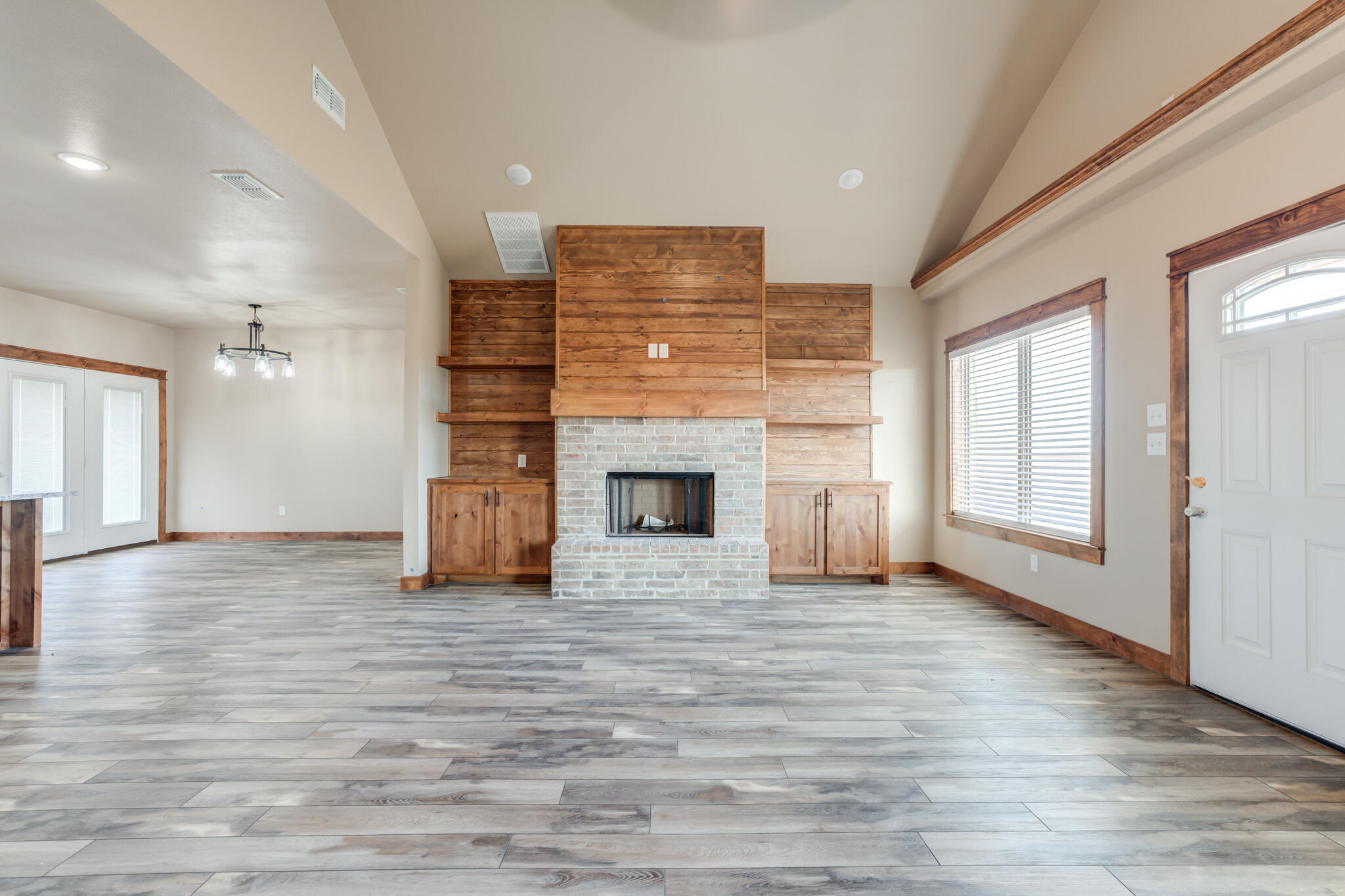 12401 North C R 2900 Lubbock, TX 79403 - Photo 7 of 40 a view of empty room with wooden floor and fireplace