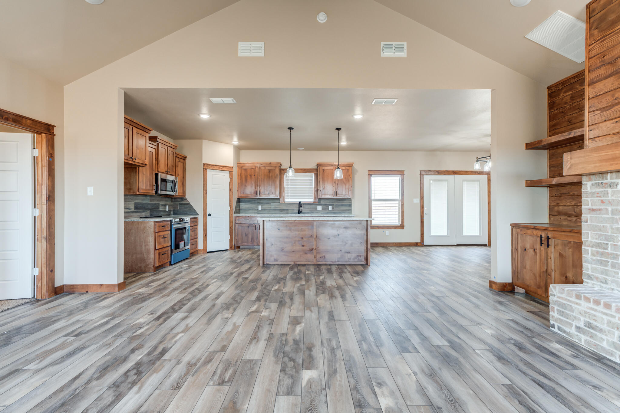 12401 North C R 2900 Lubbock, TX 79403 - Photo 9 of 40 a view of kitchen with cabinets and wooden floor