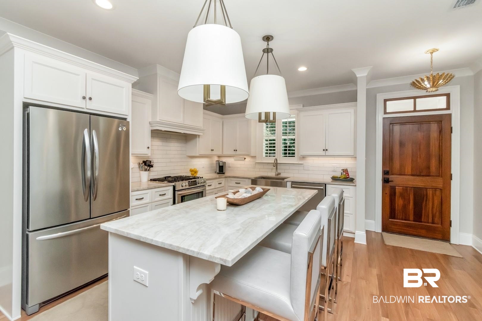 4404 Stein Street Mobile, AL 36608 - Photo 12 of 50 Kitchen with appliances with stainless steel finishes, a kitchen breakfast bar, white cabinetry, a center island, and light wood-style flooring