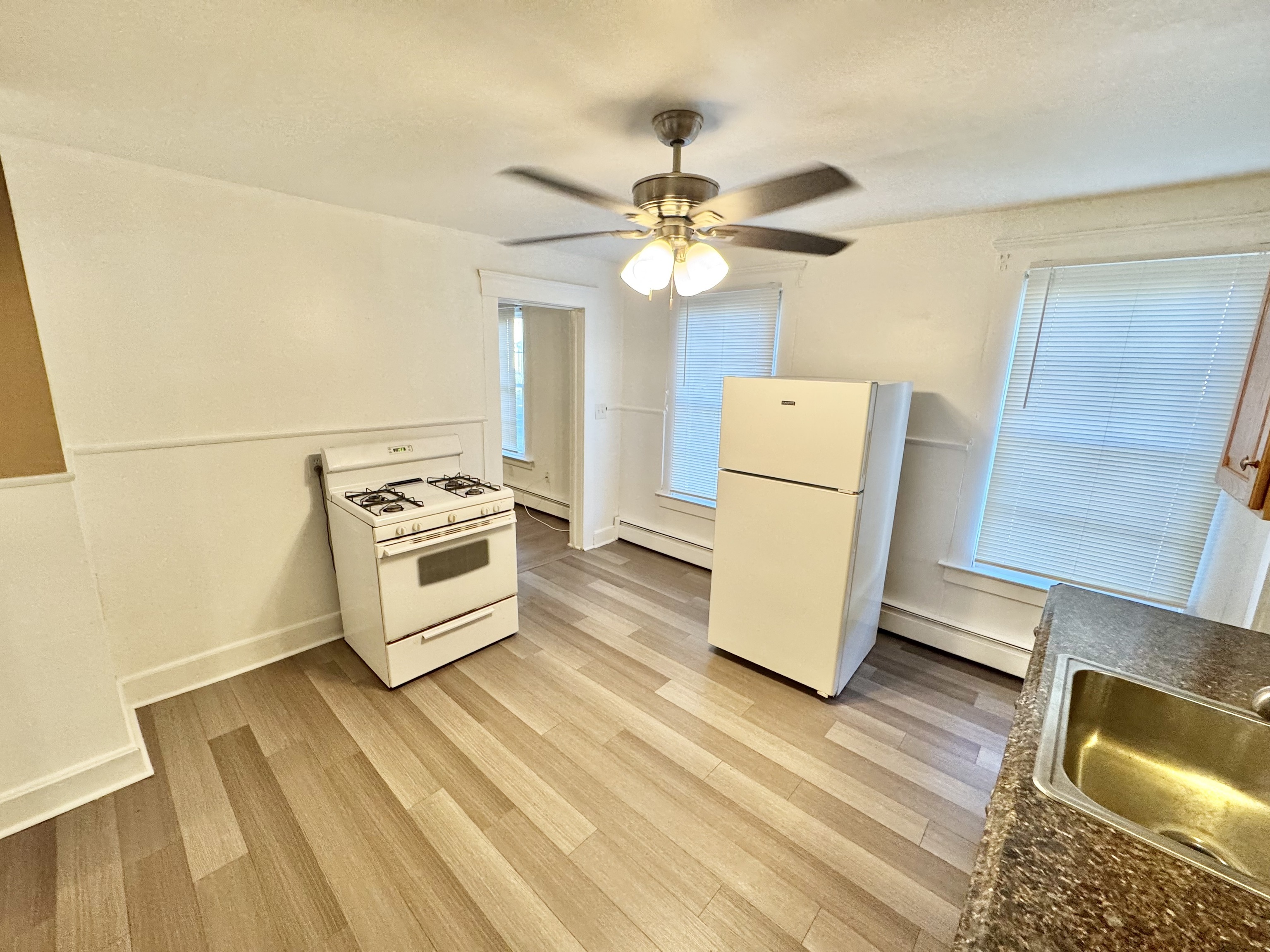 87 Butler Street New Haven, CT 06511 - Photo 3 of 10 a view of a refrigerator in kitchen and wooden floor