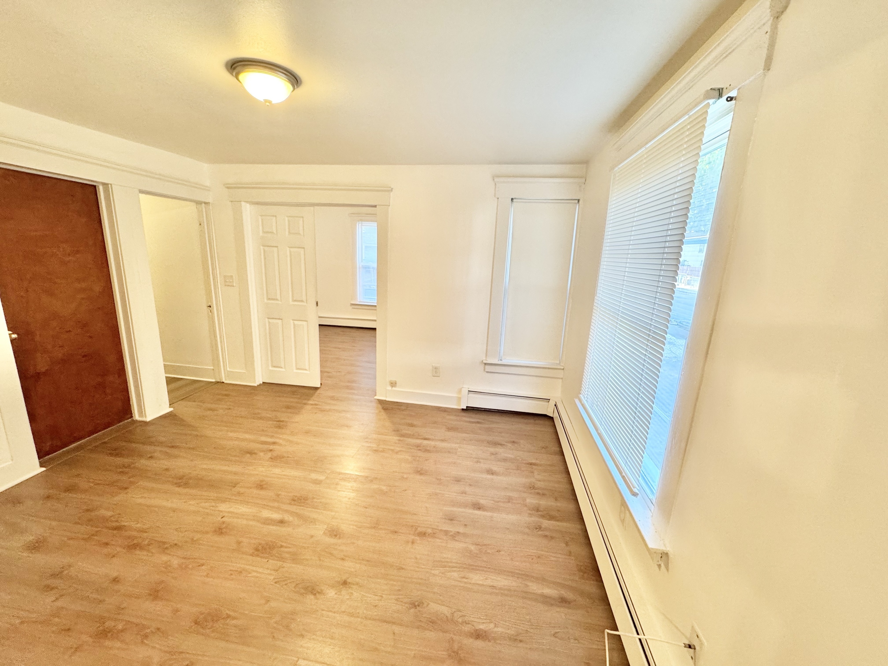 87 Butler Street New Haven, CT 06511 - Photo 5 of 10 a view of an empty room with wooden floor and a window