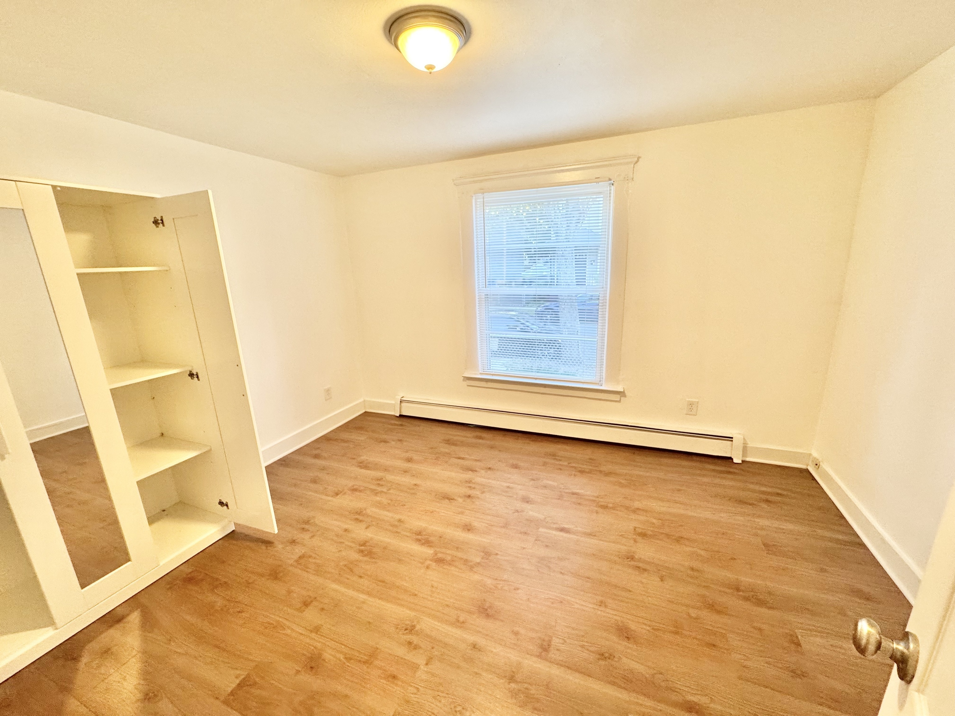 87 Butler Street New Haven, CT 06511 - Photo 8 of 10 a view of an empty room with wooden floor and a window