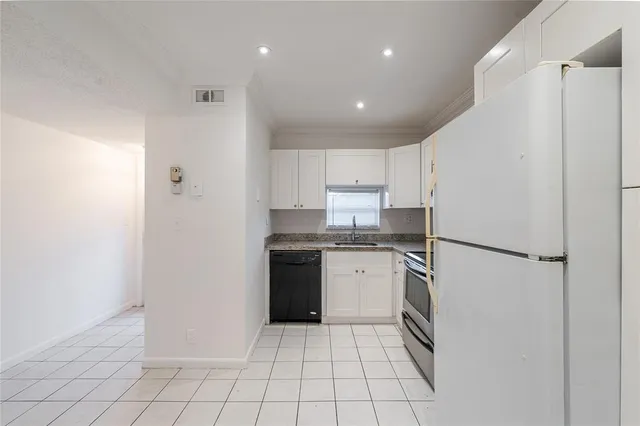 a view of a house with a big yard and large trees