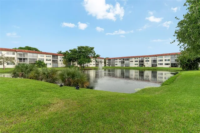 a view of a cars park in front of a building