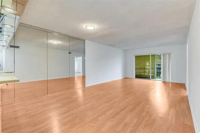a view of kitchen with furniture and refrigerator