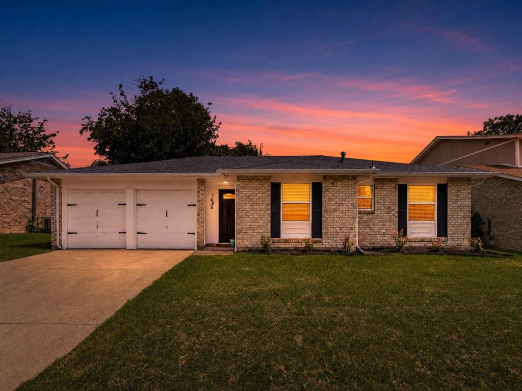 1405 Rambler Road Arlington, TX 76014 - Photo 1 of 26 Brick facade ranch home featuring a two-car garage, concrete driveway, and front lawn
