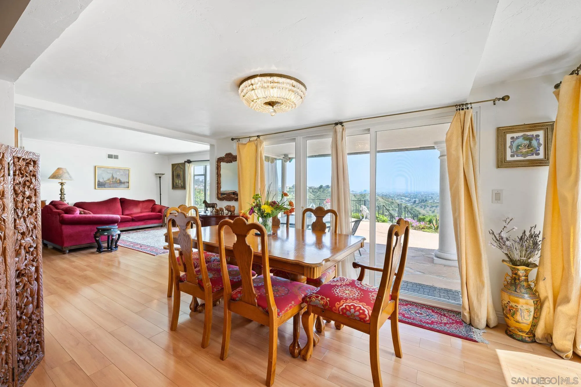 5903 Soledad Mountain Road La Jolla, CA 92037 - Photo 15 of 44 a view of a dining room with furniture a chandelier and wooden floor