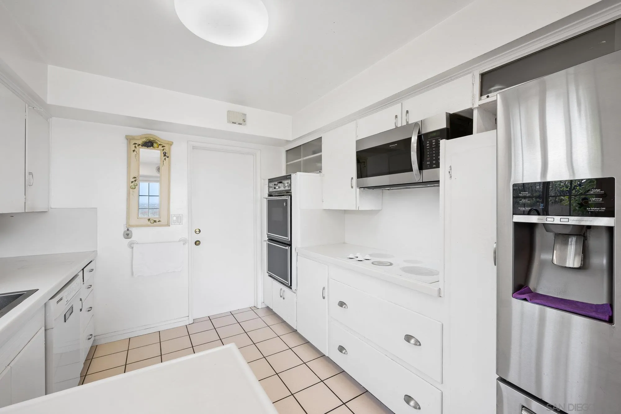 5903 Soledad Mountain Road La Jolla, CA 92037 - Photo 21 of 44 a view of kitchen with stainless steel appliances cabinets and a window