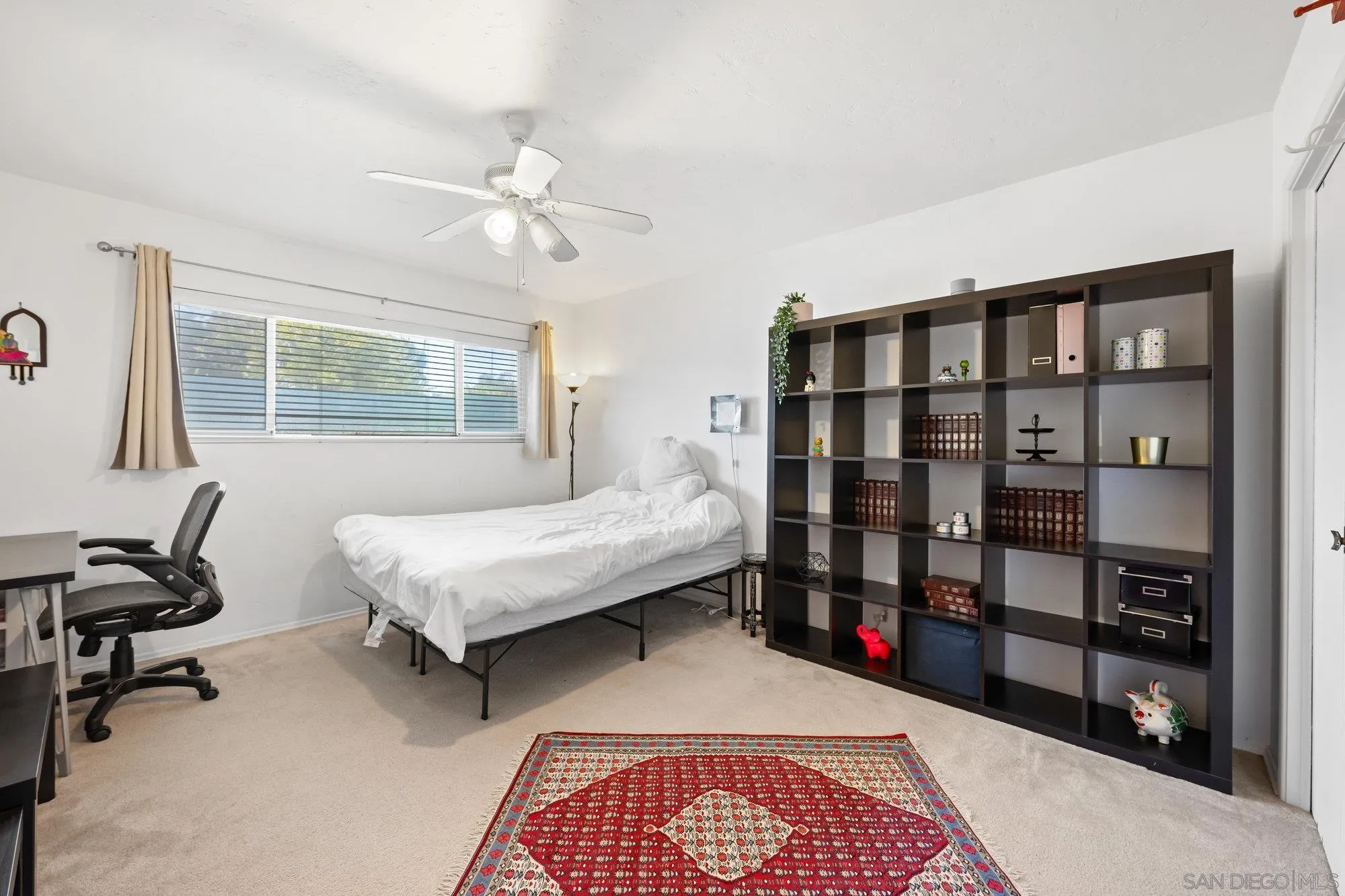 5903 Soledad Mountain Road La Jolla, CA 92037 - Photo 28 of 44 a bedroom with a large bed and a window