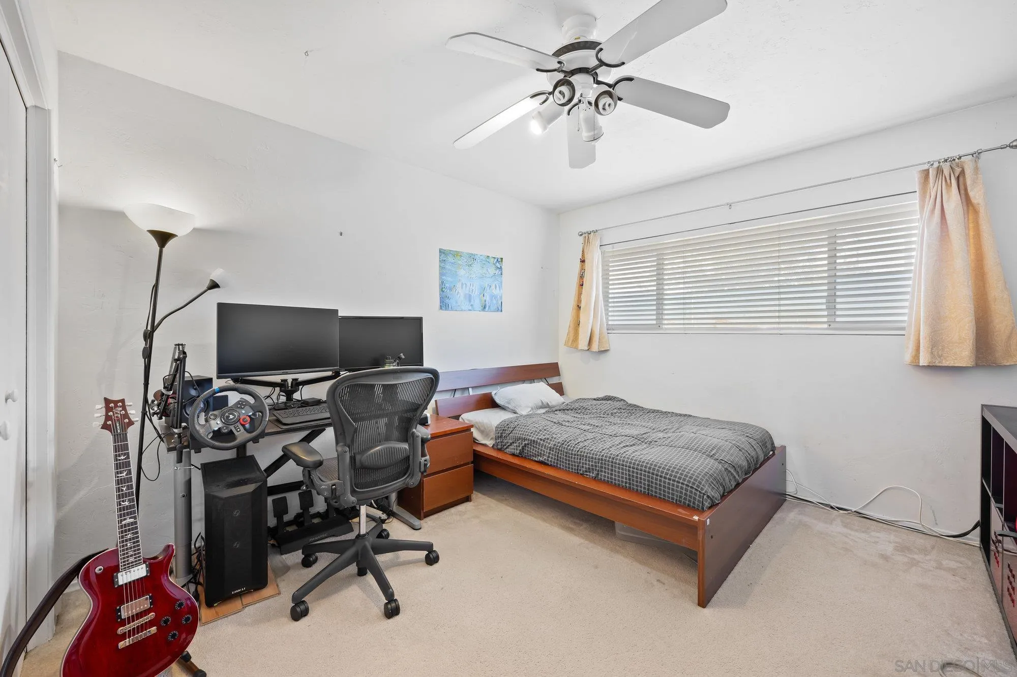 5903 Soledad Mountain Road La Jolla, CA 92037 - Photo 29 of 44 a bedroom with a bed and a chandelier