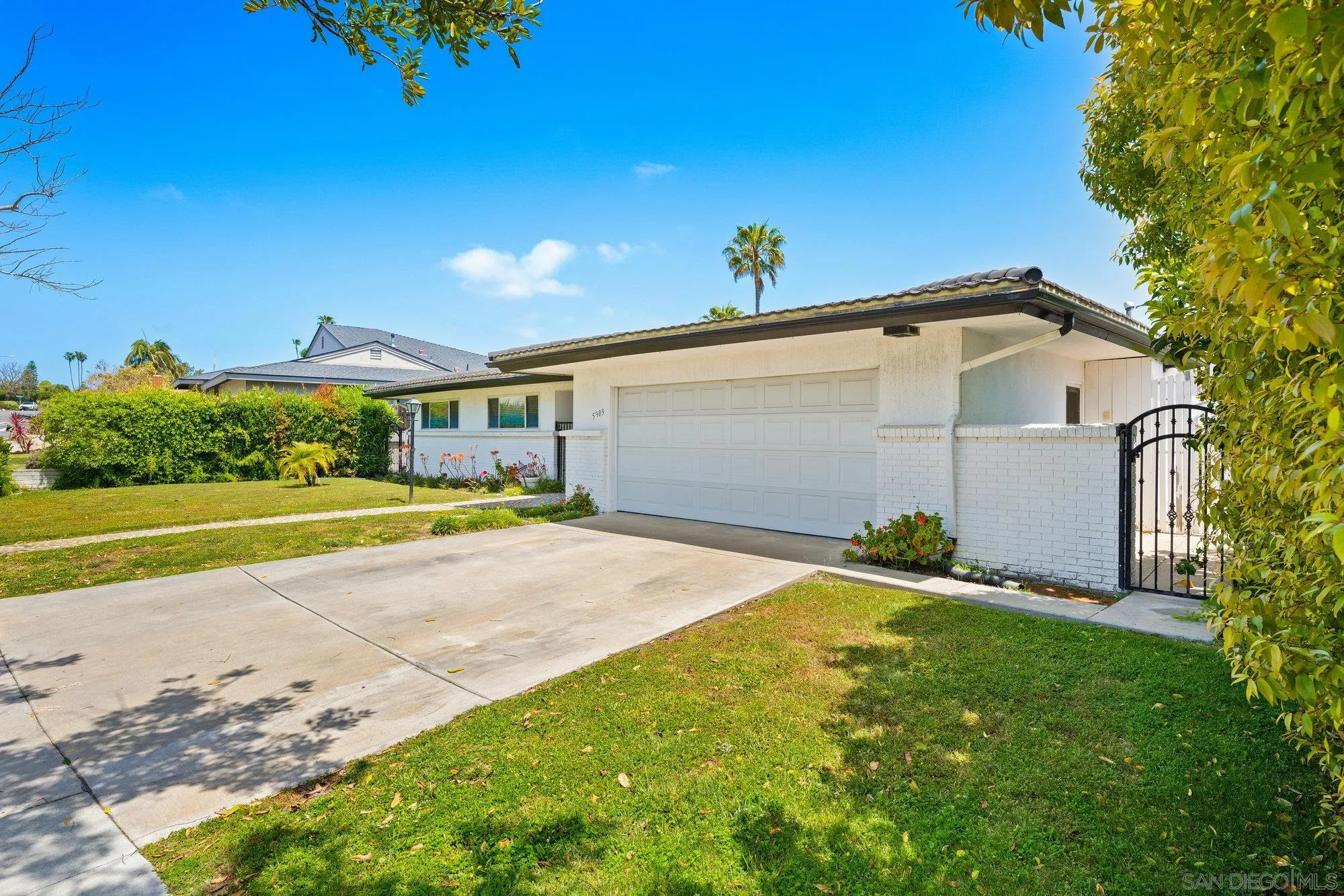 5903 Soledad Mountain Road La Jolla, CA 92037 - Photo 7 of 44 a front view of a house with a yard and garage