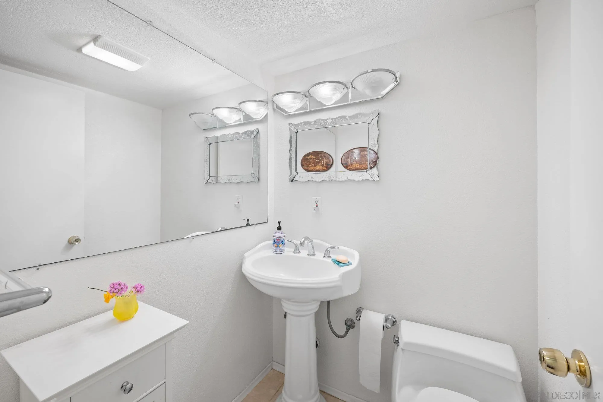 5903 Soledad Mountain Road La Jolla, CA 92037 - Photo 10 of 44 a bathroom with a sink a mirror and tub