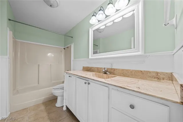 a bathroom with a toilet a sink and curtain