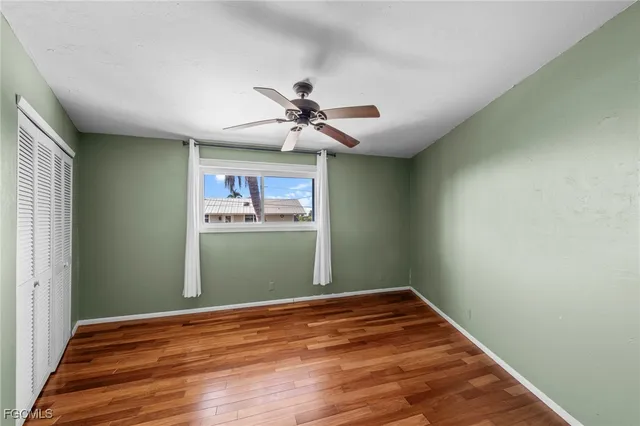 a bathroom with a granite countertop sink a toilet a mirror and shower