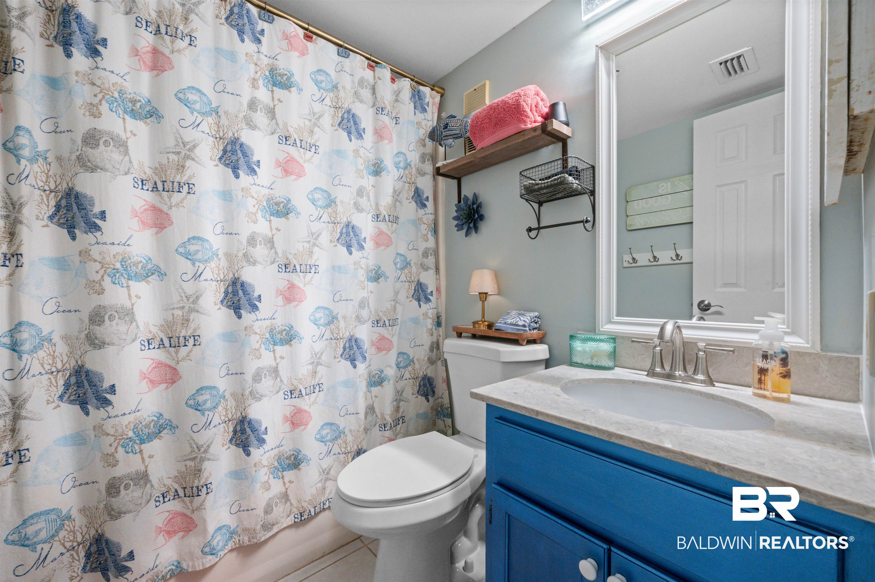 375 Plantation Road, Unit 5610 Gulf Shores, AL 36542 - Photo 14 of 33 Bathroom with vanity, light tile patterned flooring, and shower / bathtub combination with curtain