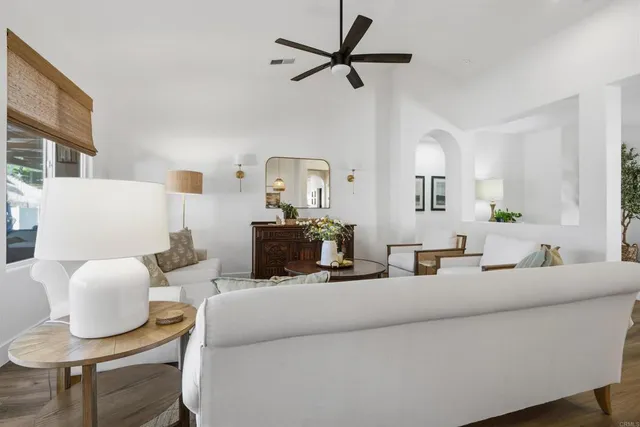 a living room with furniture and a mirror