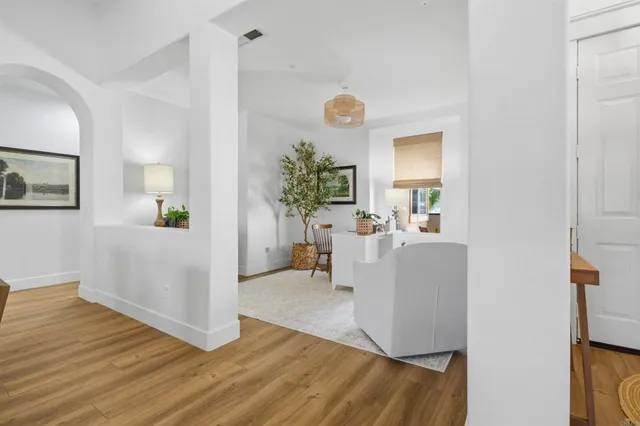 a living room with furniture and wooden floor