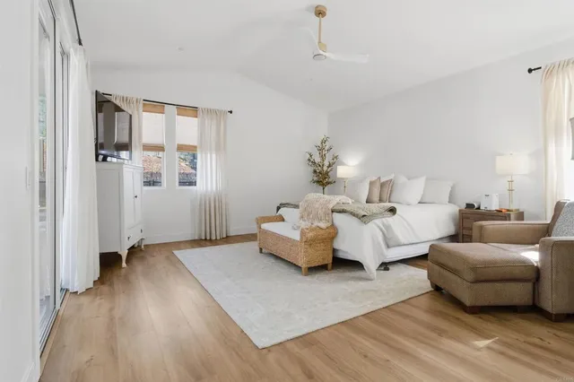 a spacious bedroom with a bed and a couch