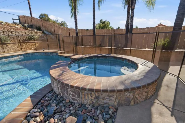 a view of swimming pool with a patio