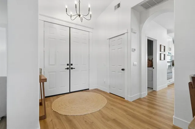 a view of a livingroom with wooden floor and a bathroom