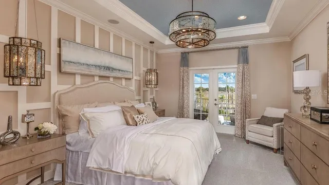 a bedroom with a bed and a chandelier