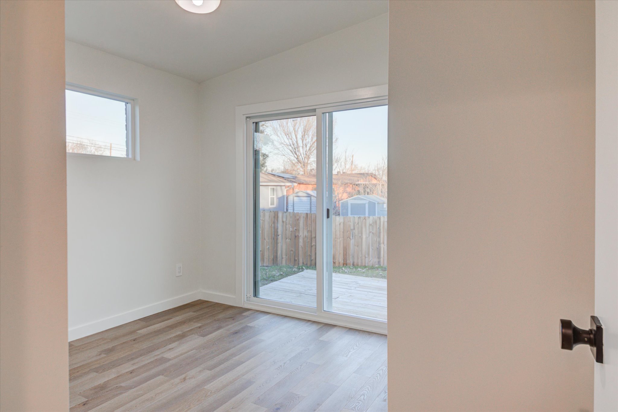 1719 Meander Drive Austin, TX 78721 - Photo 19 of 29 an empty room with wooden floor and windows