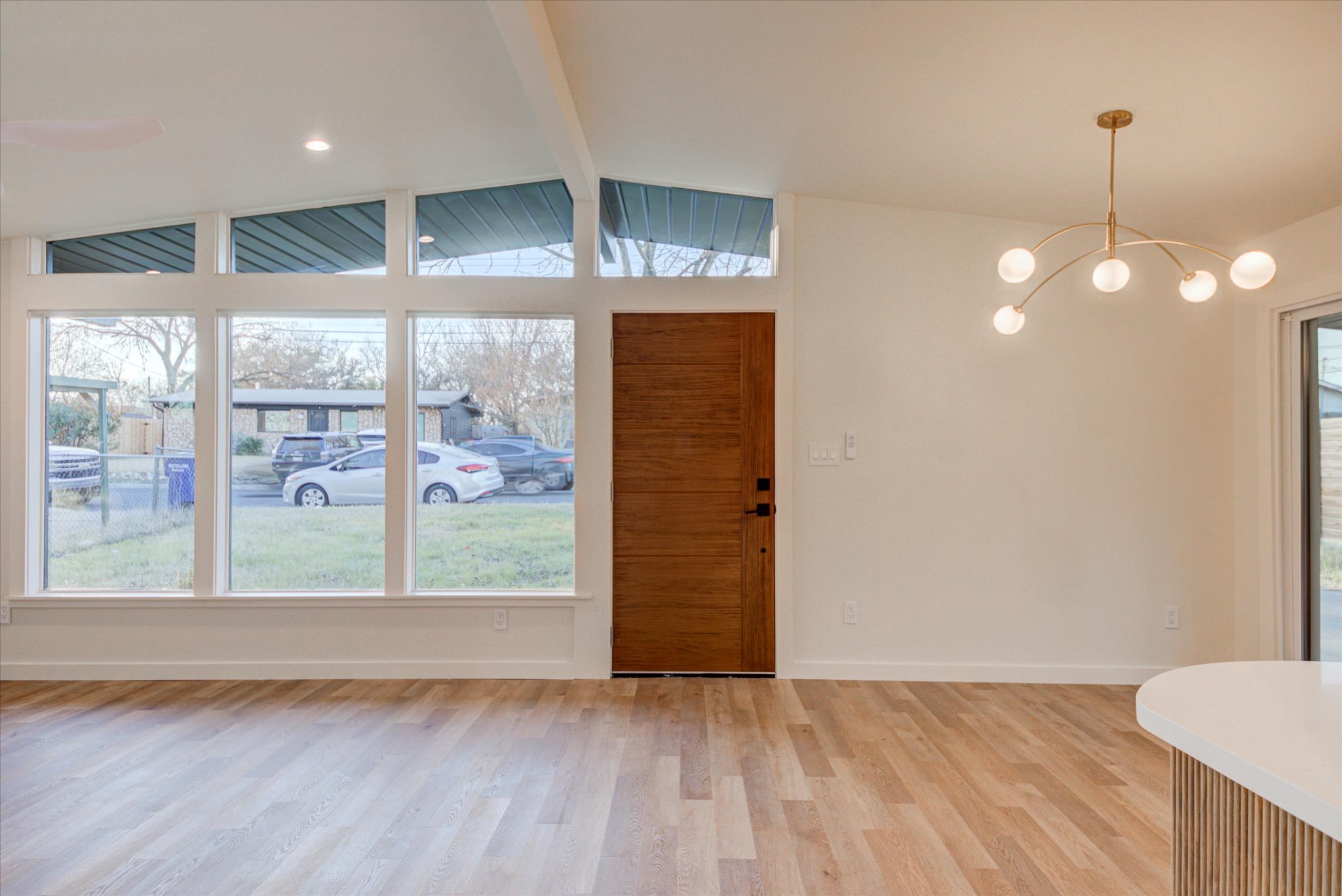 1719 Meander Drive Austin, TX 78721 - Photo 5 of 29 a view of an empty room with wooden floor and windows