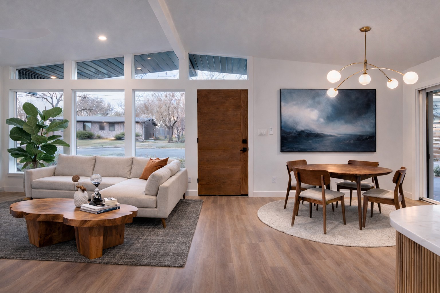 1719 Meander Drive Austin, TX 78721 - Photo 6 of 29 a living room with furniture a dining table and a flat screen tv