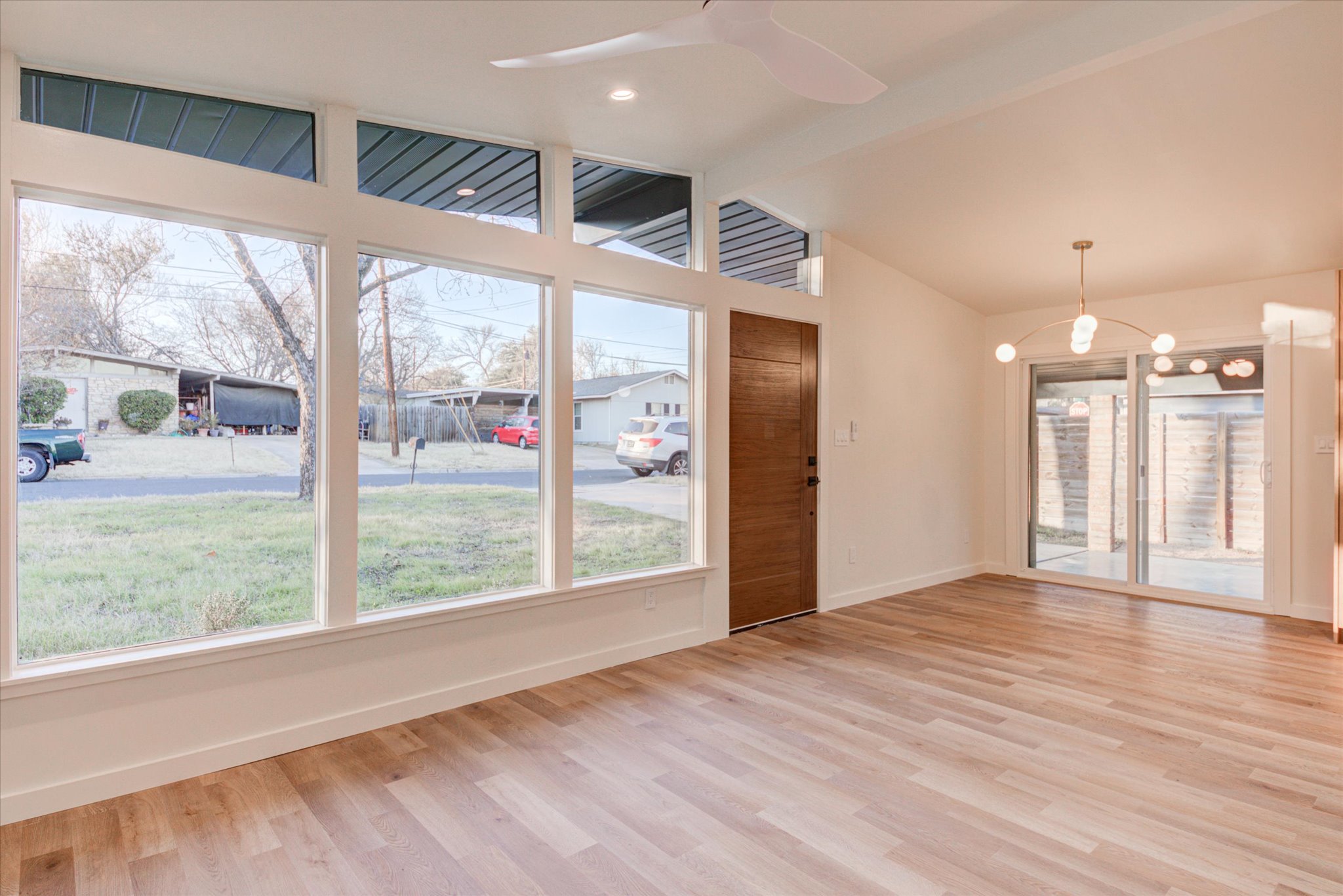 1719 Meander Drive Austin, TX 78721 - Photo 7 of 29 a view of an empty room with wooden floor and a window