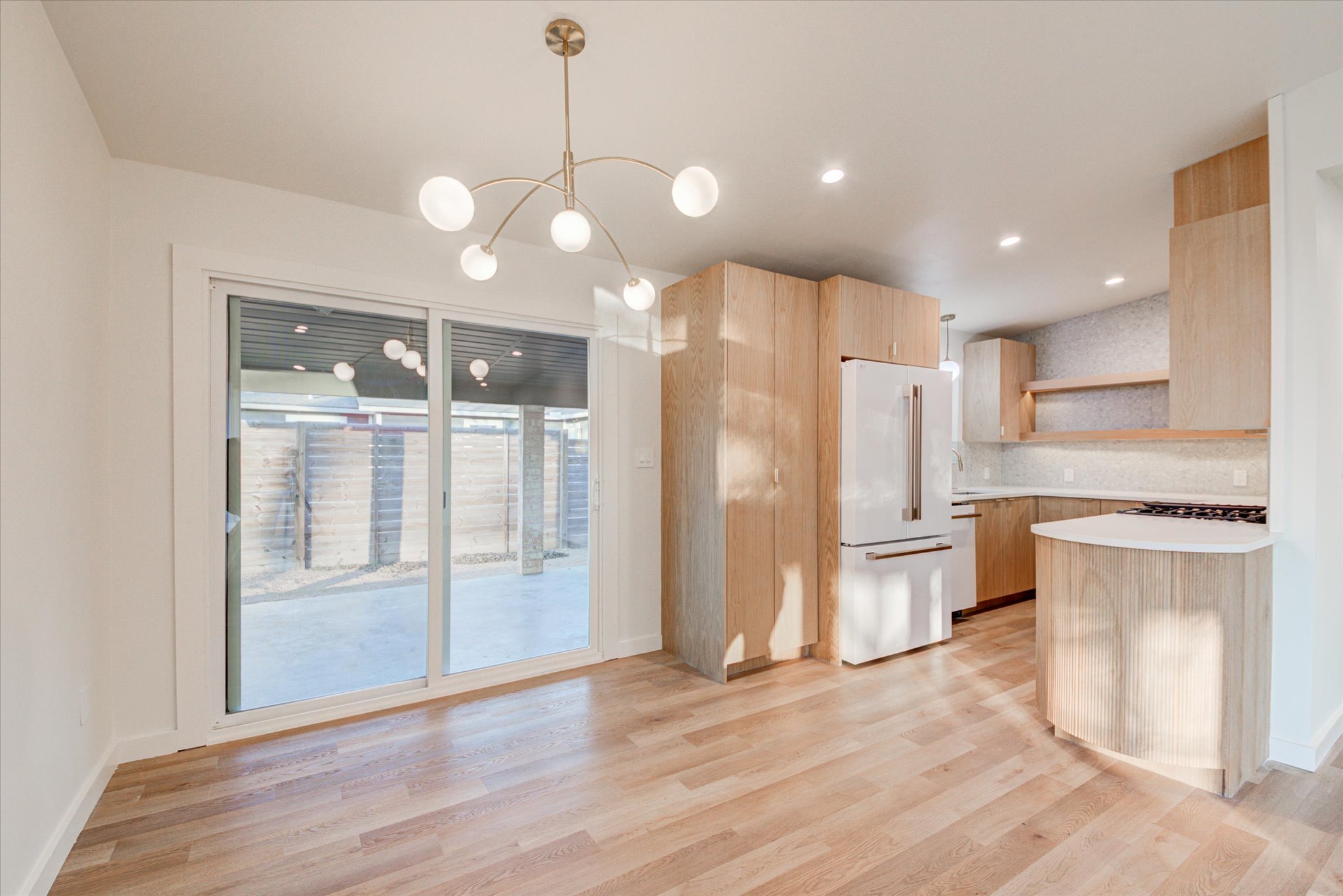 1719 Meander Drive Austin, TX 78721 - Photo 8 of 29 a view of a kitchen with wooden floor and a large window